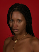 A gold necklace featuring a long chain and a heart-shaped pendant, elegantly designed for a classic look.