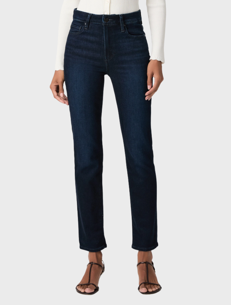 A pair of Cindy Straight Jeans hanging on a rack, featuring a timeless straight leg style in a medium wash denim.
