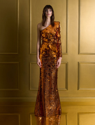 Orange prism gown with shimmering fabric, showcasing a vibrant and elegant design suitable for formal occasions.