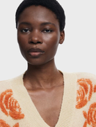 A thick gauge jacket adorned with a colorful floral print, combining comfort and fashion for chilly days.