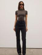 Tilly Bootleg Jean displayed backstage, showcasing its stylish design and fabric details in a fashion show setting.