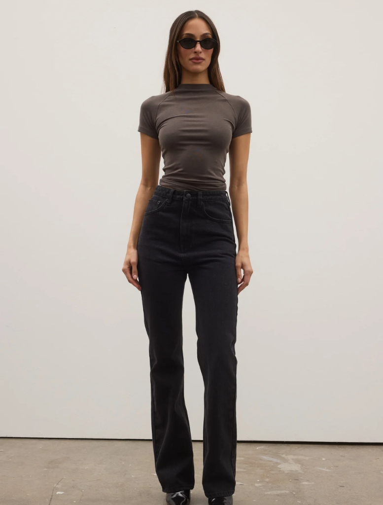 Tilly Bootleg Jean displayed backstage, showcasing its stylish design and fabric details in a fashion show setting.