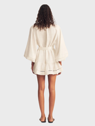 Stylish ivory mini dress featuring balloon sleeves and a short length, perfect for a fashionable summer wardrobe.