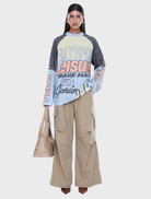 Trademark Long Sleeve Tee in Multi/Pelly Sport, featuring a relaxed fit, raglan sleeves, and bold all-over graphic print.