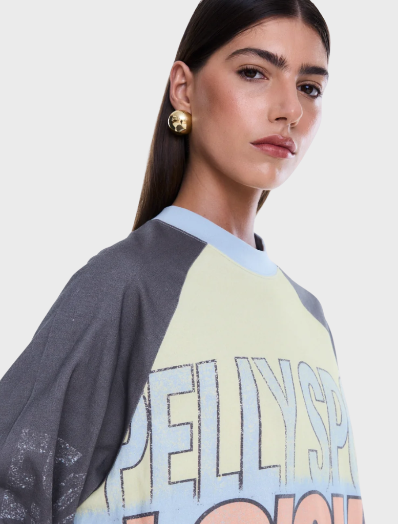 Relaxed-fit Trademark Long Sleeve Tee with raglan sleeves, classic crew neckline, and vibrant all-over yardage print.