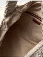A white Tulum bag featuring a new shape, designed for stylish and functional use.