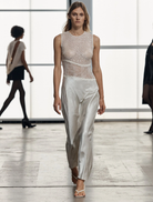 Elegant floor-length twilight dress in a soft dawn hue, featuring a flowing silhouette and delicate fabric.