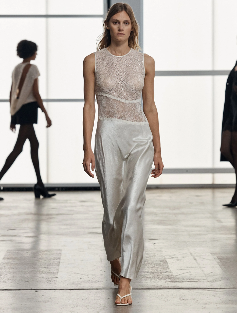 Elegant floor-length twilight dress in a soft dawn hue, featuring a flowing silhouette and delicate fabric.