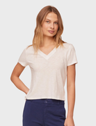 White V-neck tee displayed on a hanger, showcasing its simple and classic design.