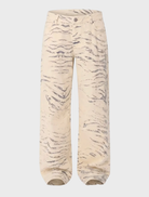 Close-up of a model in Valentina Rcy baggy jeans, highlighting the unique fabric and relaxed fit against a city backdrop.