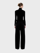 Black and off-white striped Valentina pants, combining comfort and style for a contemporary wardrobe choice.