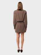 Stylish mocha Vault Bomber jacket hanging, showcasing its sleek design and color.