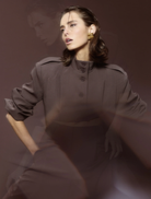 Stylish mocha Vault Bomber jacket hanging, showcasing its sleek design and color.