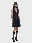 A stylish black vest hanging, emphasizing its clean lines and modern aesthetic for a polished appearance.