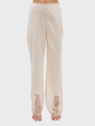 Elegant buttercream lace pant featuring a scalloped waistband and sheer lace hem, offering a refined and fluid silhouette.