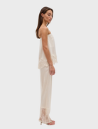 Buttercream Visions Lace Pant showcases a fluid fit, scalloped waistband, and sheer lace hem for an elegant finish.