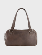  Brown leather handbag featuring two sturdy handles, displayed against a neutral background.