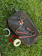 Brown leather handbag with two handles, displayed to illustrate its chic and practical features.