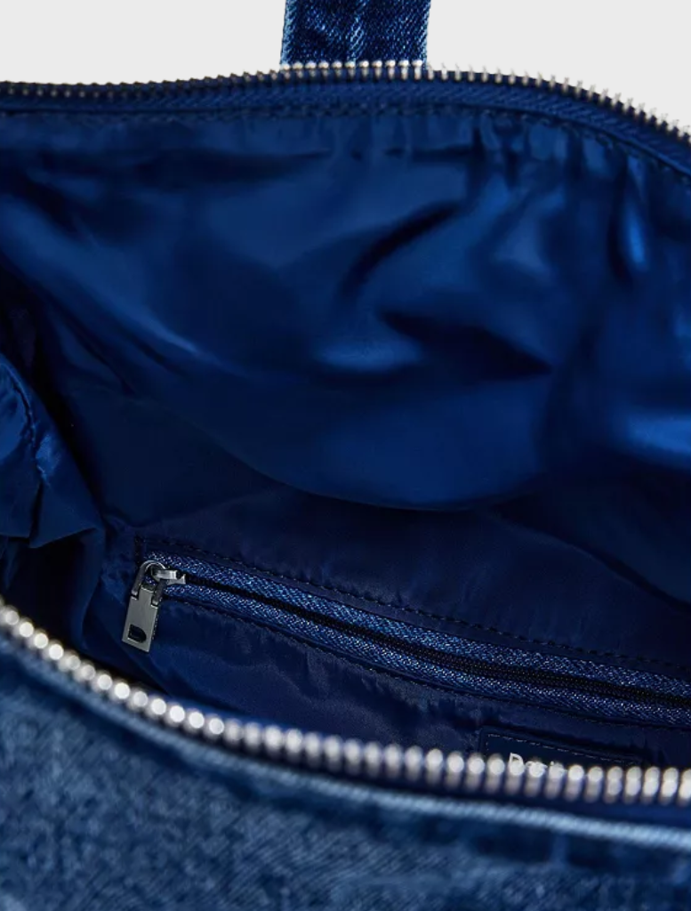 Blue denim mini backpack with a zipper closure, combining functionality and fashion for daily adventures.