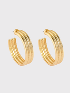 Gold triple textured hoop earrings, 4cm drop, made of recycled brass and 14k gold plated for a bold, chic look.