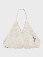 A modern white Tulum bag with a unique shape, perfect for adding a chic touch to any outfit.
