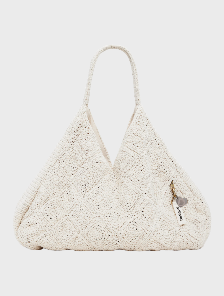 A modern white Tulum bag with a unique shape, perfect for adding a chic touch to any outfit.