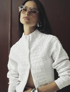 Elegant white Carter Cardigan shown on a hanger, showcasing its long sleeves and cozy fabric for a stylish look.