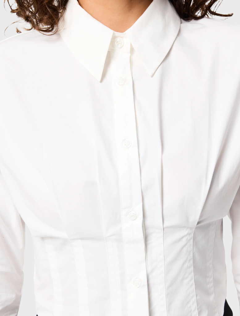 White Darcy shirt on a mannequin, highlighting its crisp design and structured collar.
