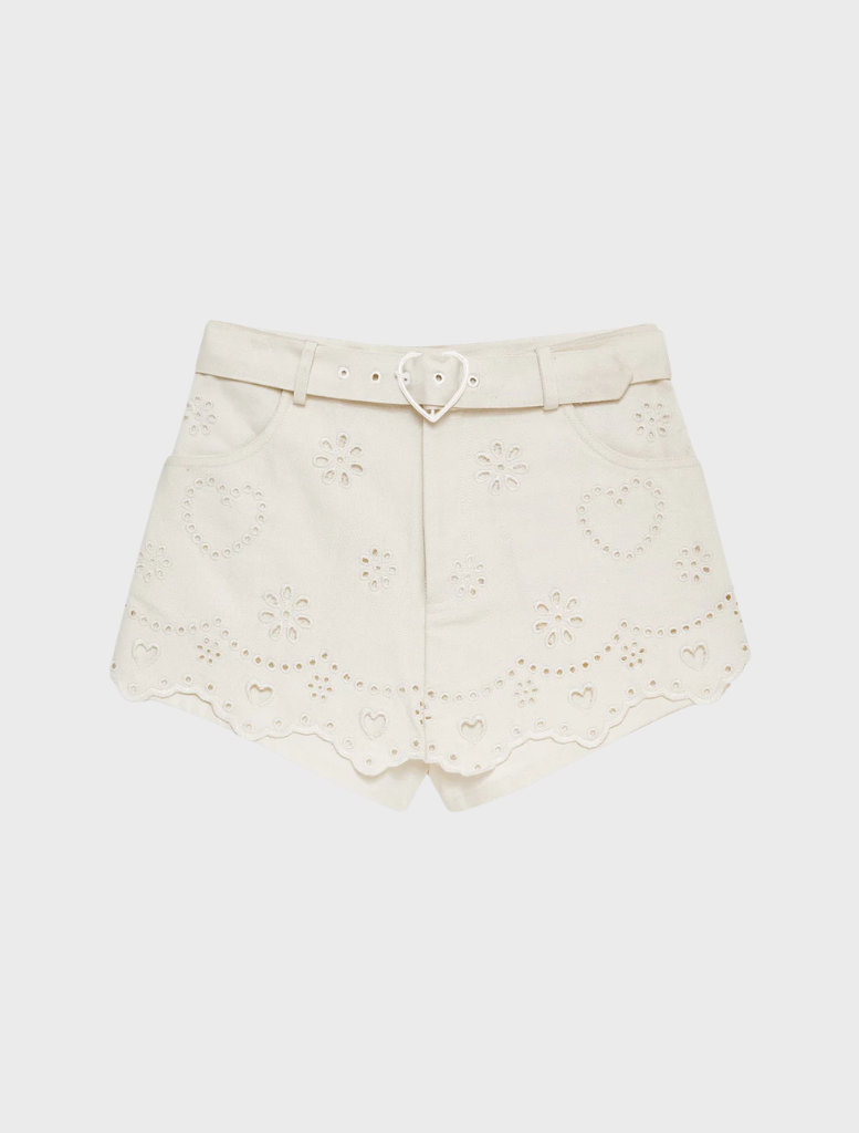 White skort made of denim with heart-shaped eyelet accents, combining comfort and trendy style for summer.