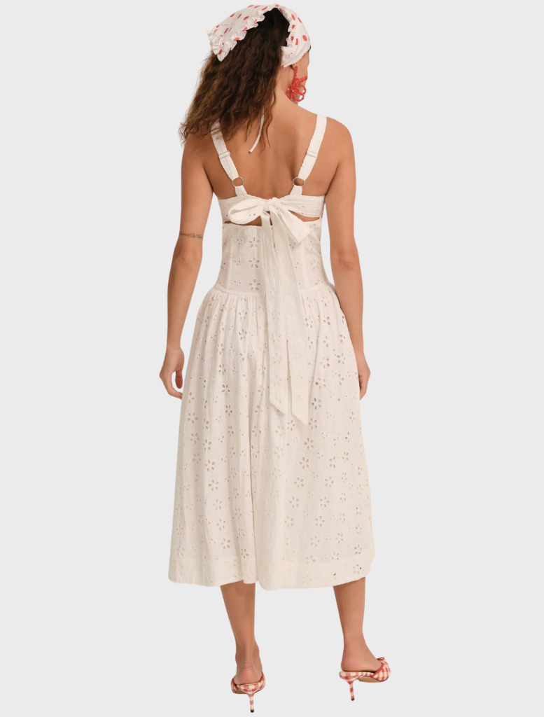 Elegant white midi dress adorned with a dreamy daisy pattern, showcasing a soft, flowing design perfect for any occasion.