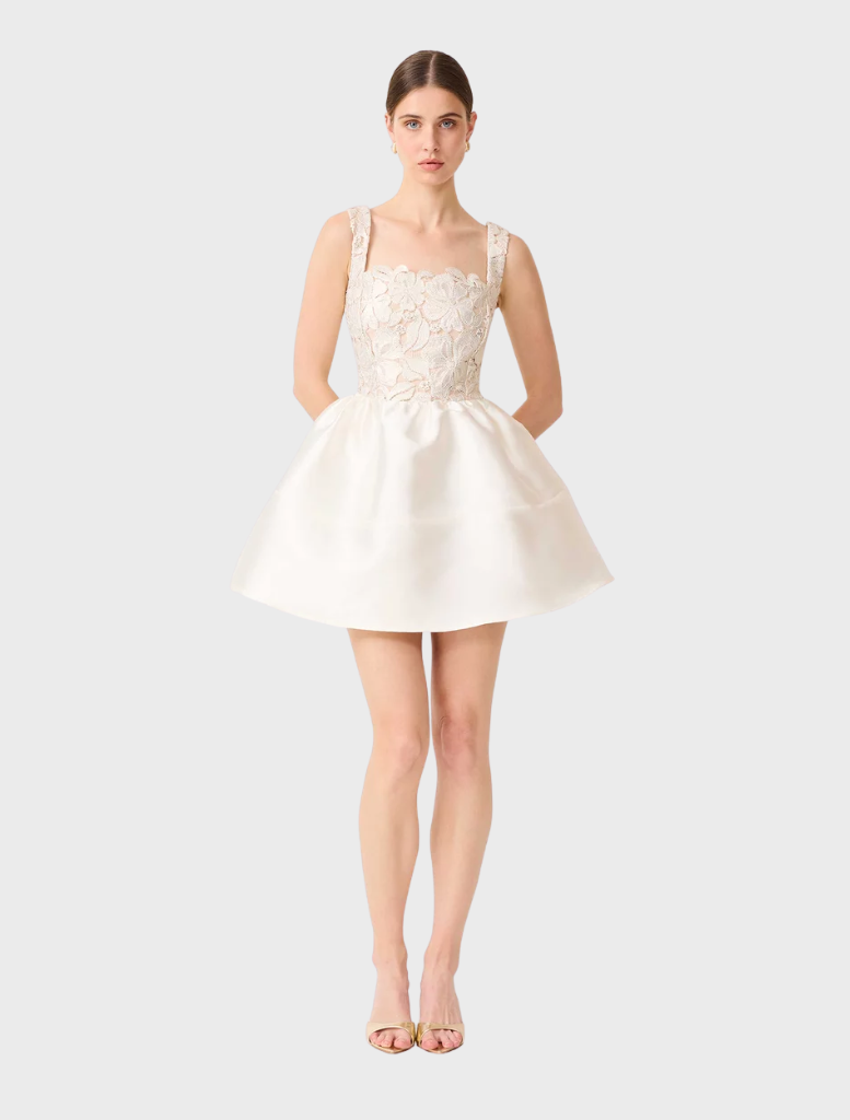Chic white and gold A-line mini dress, showcasing a tailored bodice and a playful skirt, ideal for summer events.