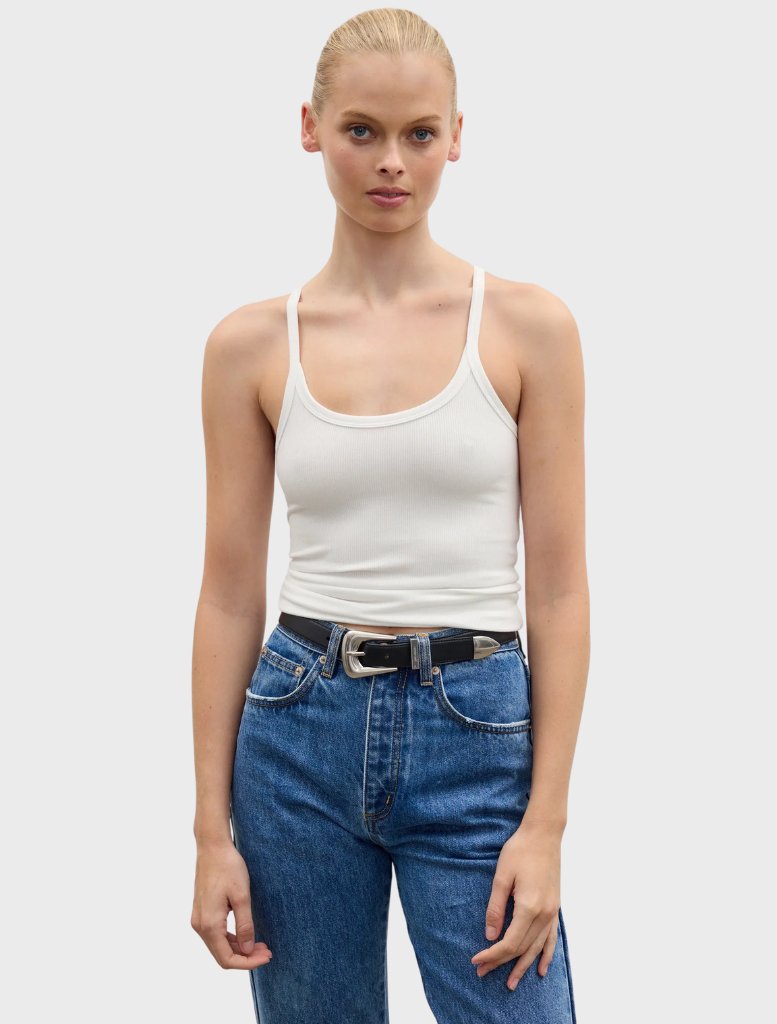 A white Jayla tank top hanging, showcasing its minimalist style and breathable material ideal for casual wear.