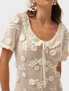 White Sara romper with a modern silhouette, suitable for both casual and semi-formal occasions.