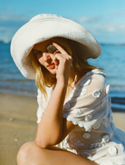 White Sara romper featuring a stylish design, perfect for casual outings or summer events.