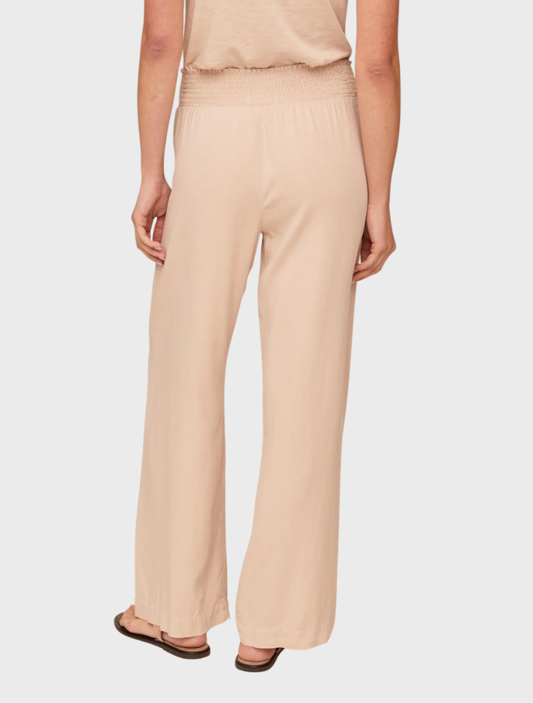 Linen sand wide-leg pants with a smocked waist, offering a chic and relaxed silhouette for casual wear.