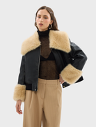 Elegant black Willow Jacket designed with shearling accents, oversized collar, and relaxed fit for casual or polished looks.