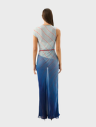 Long Capri maxi dress with a colorful striped design reminiscent of the sea's hues and patterns.