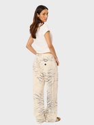 Fashionable baggy jeans by Valentina Rcy worn by a model, set against an urban landscape, illustrating modern style.