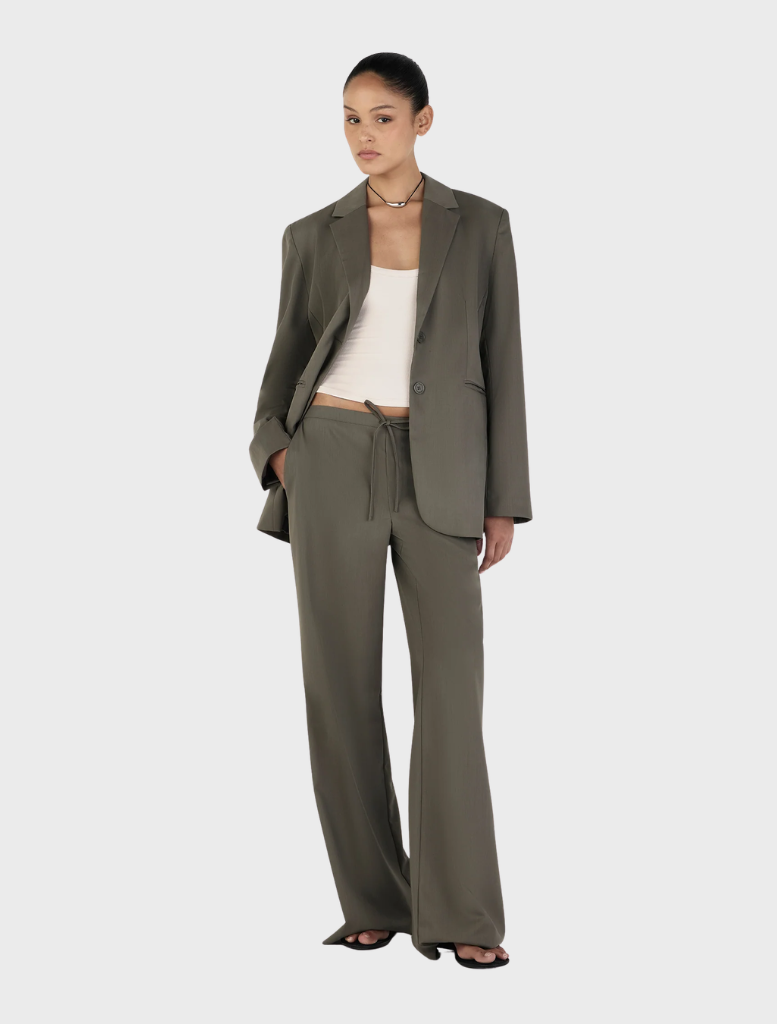 Forest green Isla Blazer, showcasing a modern cut and refined design, displayed on a hanger for visibility.