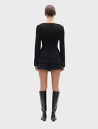 Tailored black Laurent blazer on a hanger, emphasizing its stylish fit and classic design for business wear.