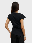Stylish black Liana top showcased on a hanger, featuring a minimalist design and soft texture.