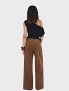 Tan Max Cord Pants arranged neatly, emphasizing their stylish cut and warm color.