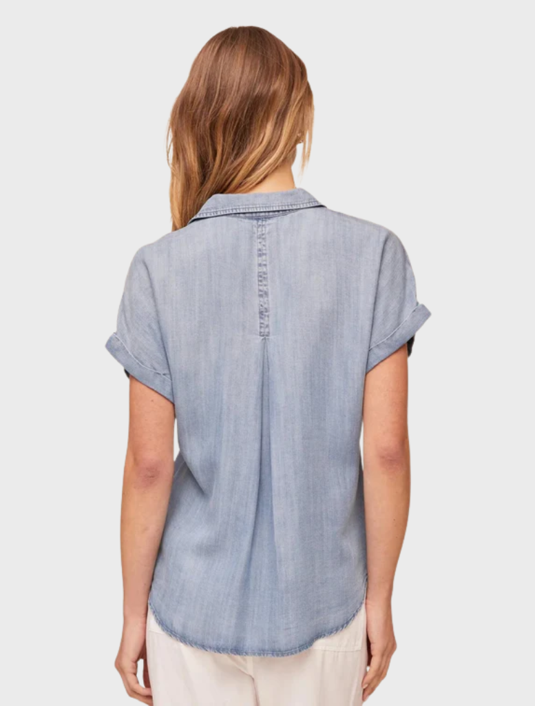 Worn blue wash short sleeve button-down shirt featuring a chest pocket.
