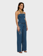 Fitted bluestone denim bustier showcasing a structured design, suitable for both casual and dressy occasions.