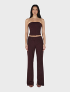 Model showcases a burgundy striped top paired with wide-leg pants, featuring the Yolanda Suit Pant in Cherry Choc Stripe.