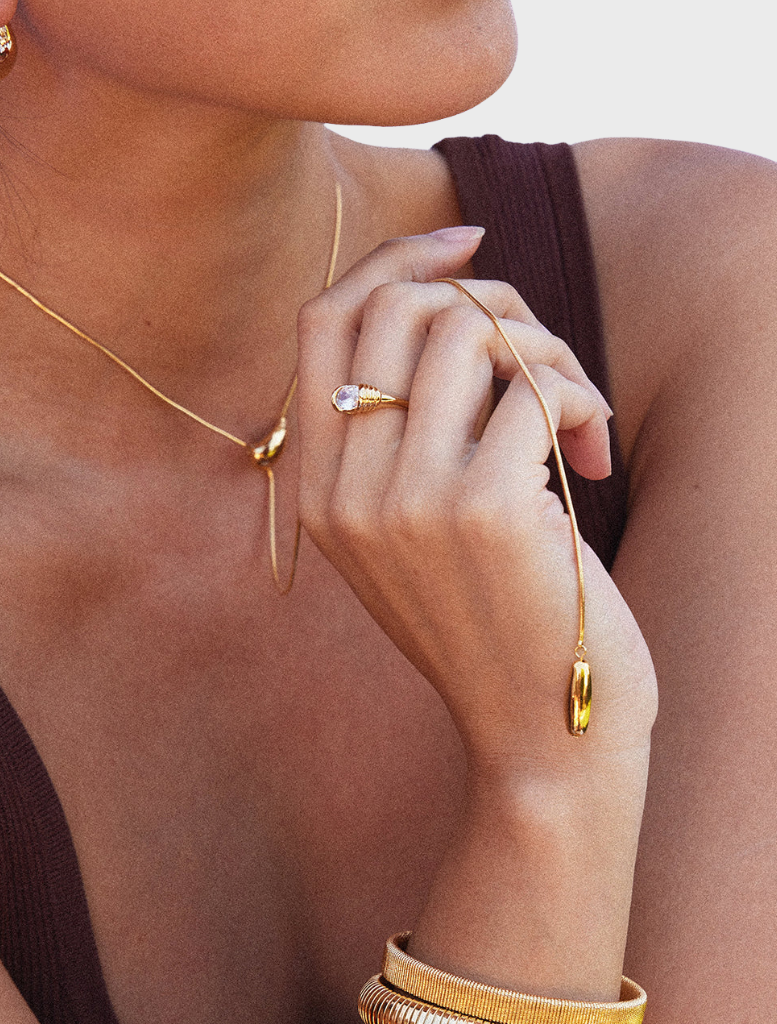 Gold Yunna necklace elegantly arranged, highlighting its unique design and shimmering finish.