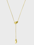 Gold Yunna necklace displayed on a white background, featuring an elegant design with intricate detailing.